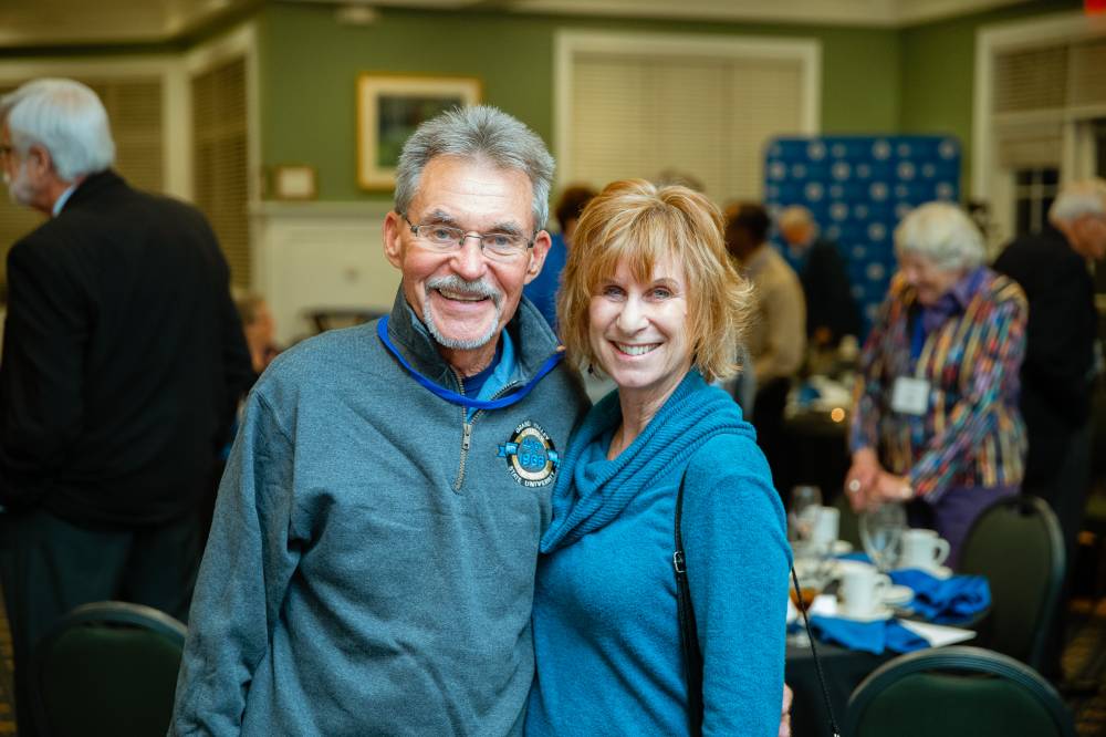Two alumni pose for a photo at the Reunion Dinner.